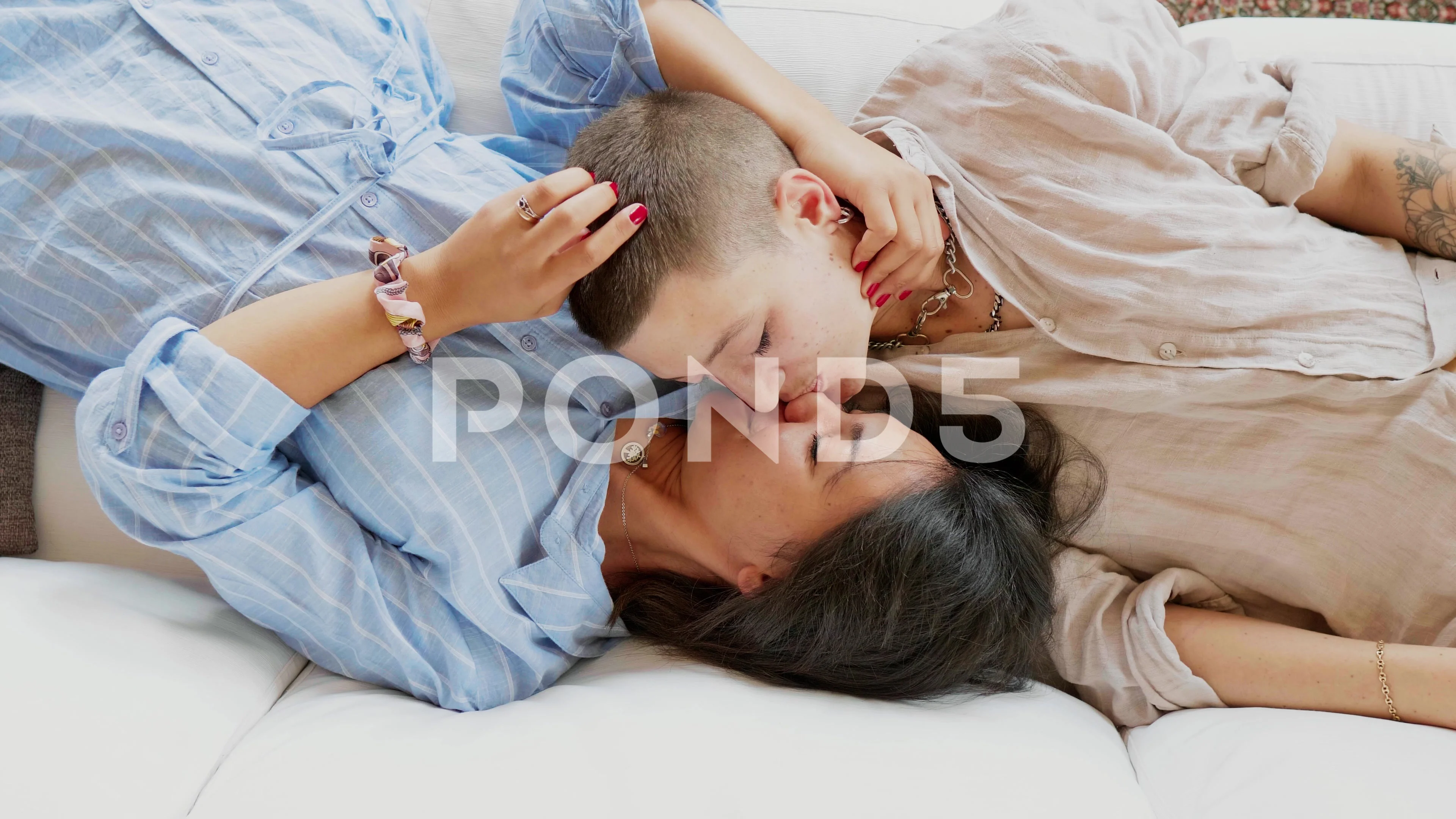 lesbians kissing on couch